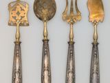 four different types of silverware are displayed on a white surface