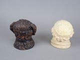 two statues of a dog and a bust of a man