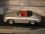 a silver model of a sports car in a display case