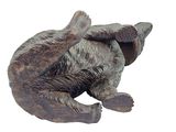 a statue of a bear laying down on its back