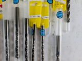 a lot of drill bits that are on the table