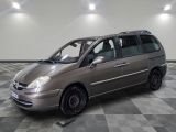a picture of a silver minivan parked in a room