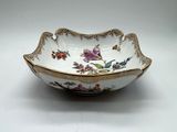a close up of a bowl on a table with a white background