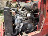 a red truck that has a large engine in it