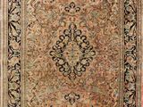 an antique persian rug with a floral design on a beige ground