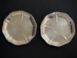 pair of silver plated trays on a black surface