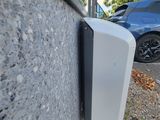 a white toilet paper dispenser on the side of a building