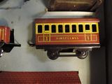 a small toy train on the table next to other toy trains