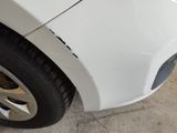 a close up of a car ' s front bumper and tire