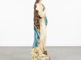 a statue of a woman holding a child in her arms