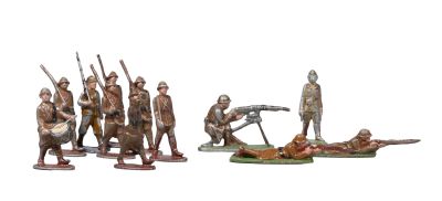 several figurines of soldiers and a dead man in a field