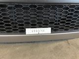 the front grille of a car with a sticker on it