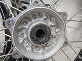 a close up of a motorcycle wheel on a white surface