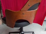 a desk chair with a wooden seat and black wheels