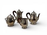 three pieces of silver tea and coffee set on a white surface