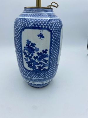 a blue and white vase with flowers on it