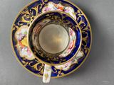 a close up of a cup and saucer on a table