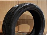 tire on the floor next to a cardboard box with a cardboard box in the background