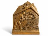 bronze sculpture of a man and woman in a hut with wheat in it