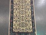 an oriental rug on a table in a room with other items