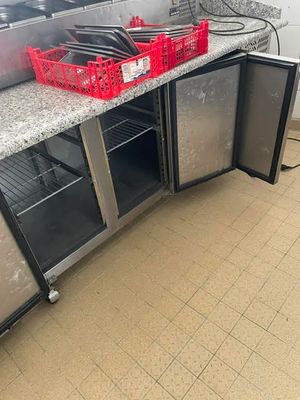 a counter with a bunch of pots and pans on it