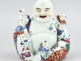 chinese figurine of a laughing buddha surrounded by other figurines