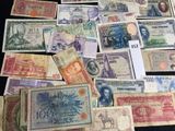 many different types of foreign currency on the table