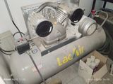 an air compressor sitting on the floor in a room