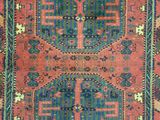a red rug with blue and green designs on it