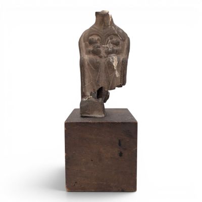 a statue of a woman sitting on top of a wooden block