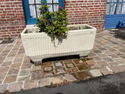a planter that is sitting on a brick sidewalk