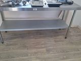 a stainless steel table with a lot of tools on top of it
