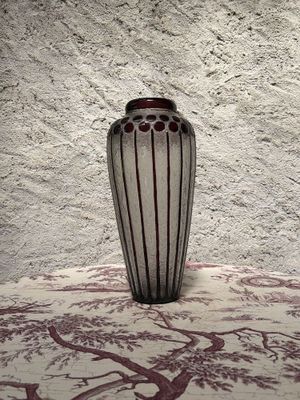un vase posé sur une table devant un mur