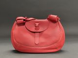 a red purse with a bow on the front of it
