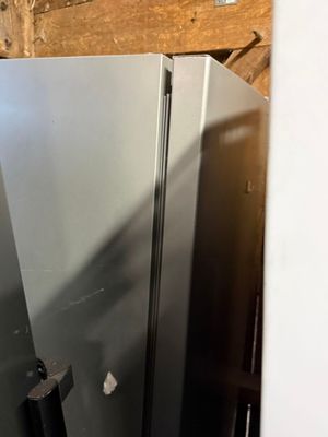 an image of a stainless steel refrigerator in a room