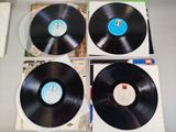 three black vinyl records sitting on top of each other on a table