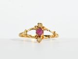 an image of a gold ring with a ruby stone in the center