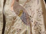 a silk jacket with a bird embroidered on it