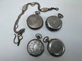 three silver pocket watches and a chain on a white surface