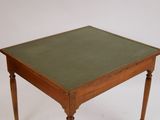 a small table with a green top on a white background