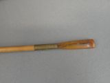 an old baseball bat sitting on top of a table next to a cup of coffee