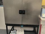 an image of a kitchen with a metal cabinet and a water dispenser