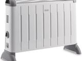 a white electric heater sitting on top of a white table