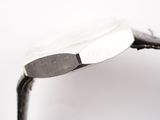a close up of a watch on a white surface