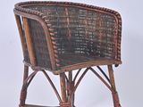 a wicker chair that is sitting on a white surface