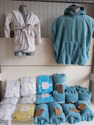 a shelf with towels, blankets, and other items on it