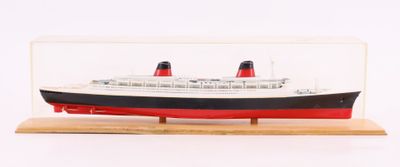 a model of a ship in a glass case on a wooden stand