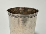 a silver cup that is sitting on a table
