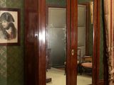 a cabinet with a mirror on it in a room