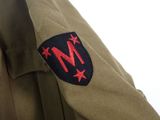 a close up of a military uniform with a badge on it